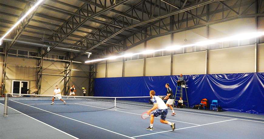 Sports Hall tennis players enjoy safe easy access play steel building